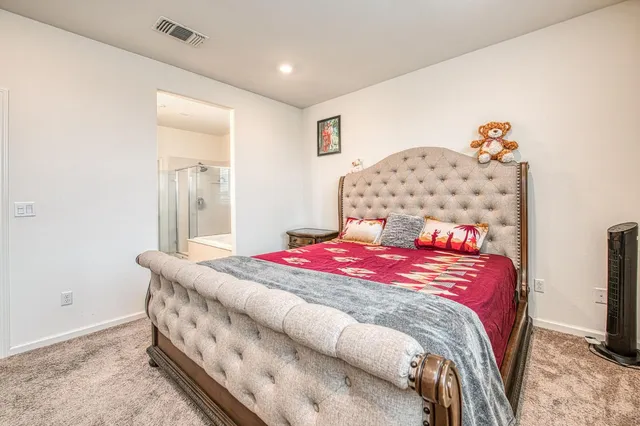 a bathroom with a tub sink shower and two mirror
