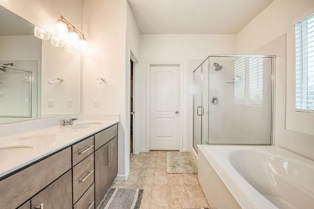 a bathroom with a bathtub and a shower