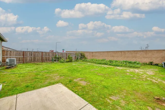 a view of a house with a yard and a garden