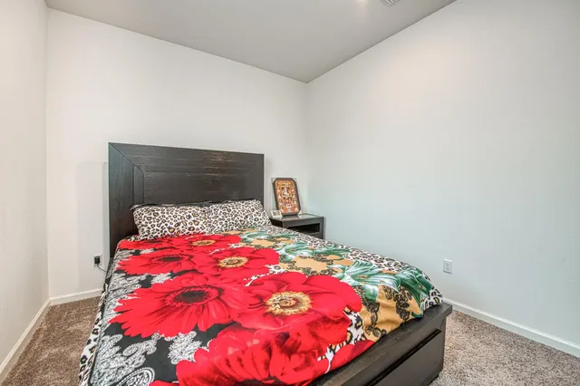 a bathroom with a sink a toilet a mirror and shower