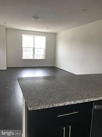 a kitchen with stainless steel appliances granite countertop a sink and a stove top oven