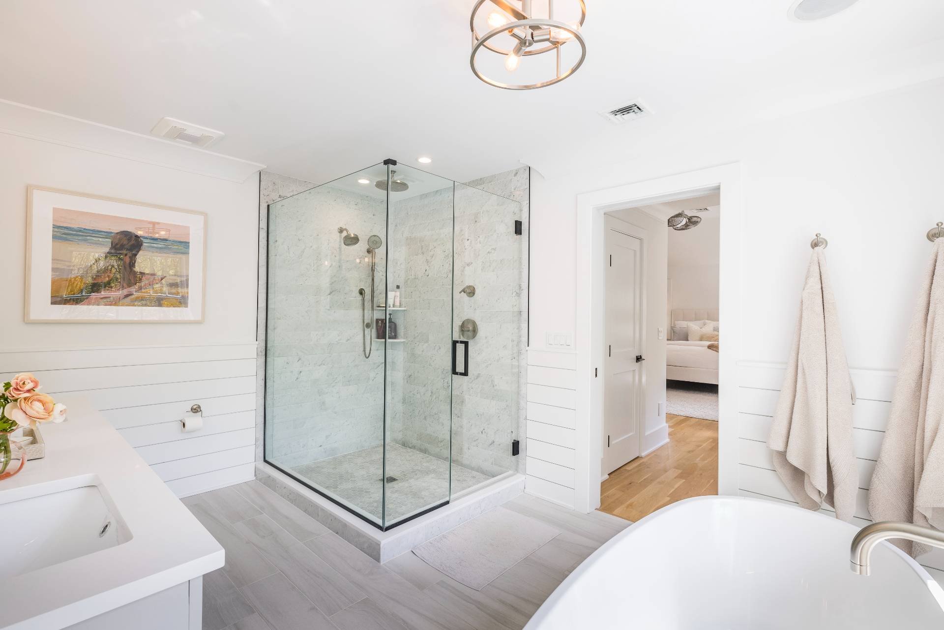 7 Park Street East Hampton, NY 11937 - Photo 14 of 23 a spacious bathroom with a glass shower a sink and a mirror