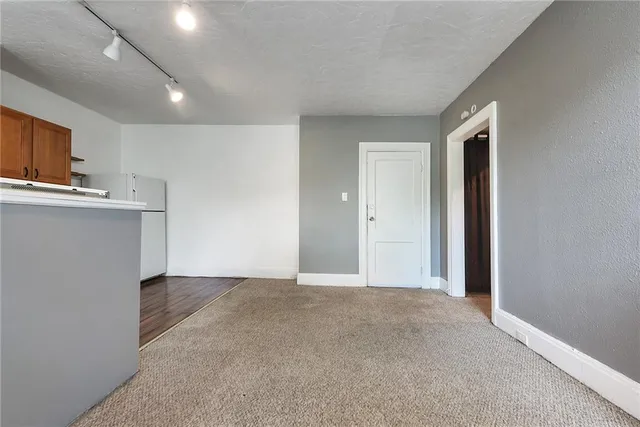 a view of a kitchen with a sink and a refrigerator
