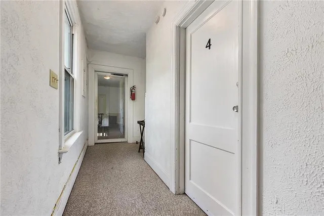 a view of a hallway with a wooden floors