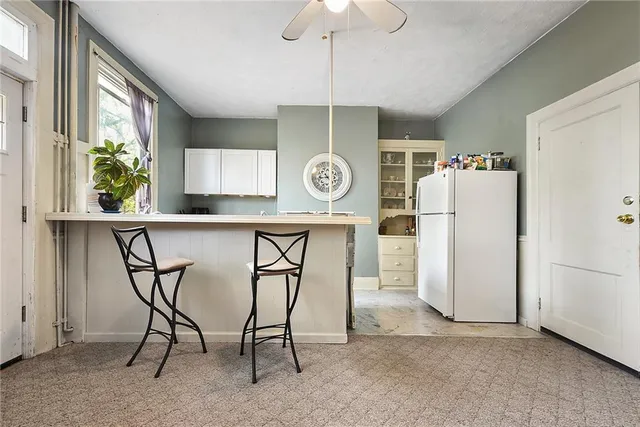 a kitchen with stainless steel appliances a refrigerator and a table