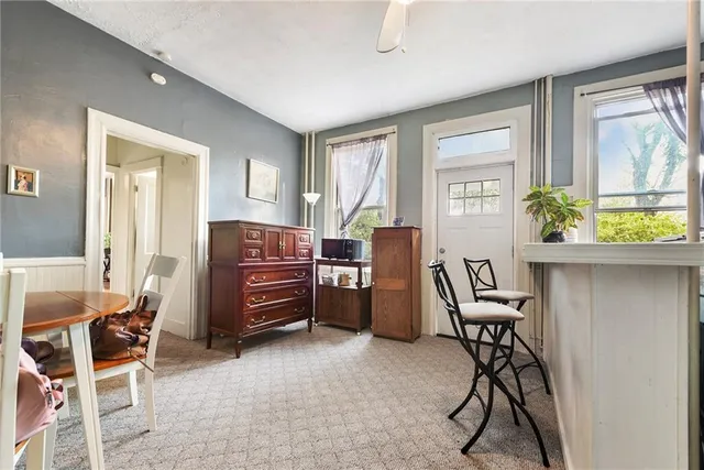 a livingroom with workspace and a window