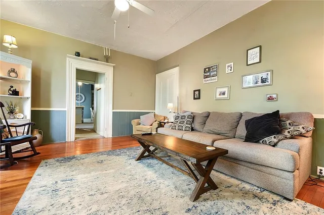 a living room with furniture and wooden floor