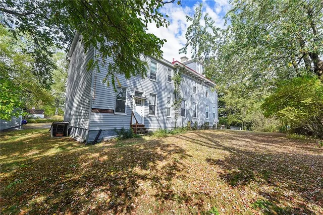 a view of a house with a yard and tree