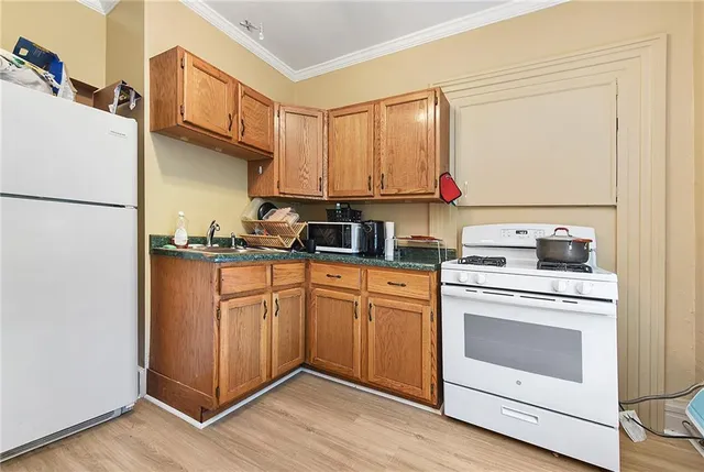 a kitchen with stainless steel appliances granite countertop a stove a sink and a refrigerator