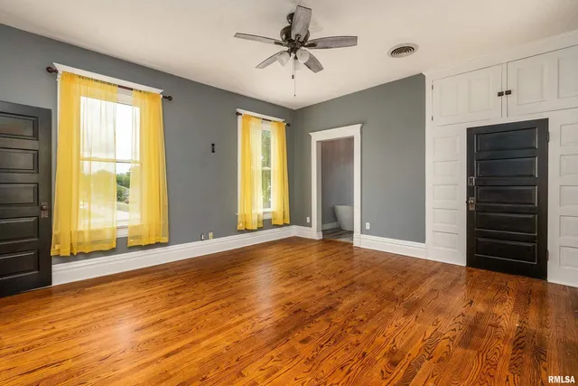 a view of a room with wooden floor