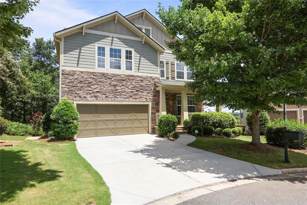 a front view of a house with a yard and trees