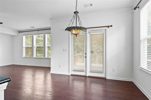 a view of wooden floor and windows in a room