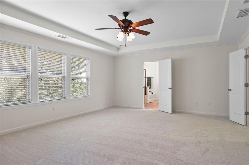 3935 Silver Springs Road Cumming, GA 30041 - Photo 19 of 37 an empty room with a ceiling fan and window