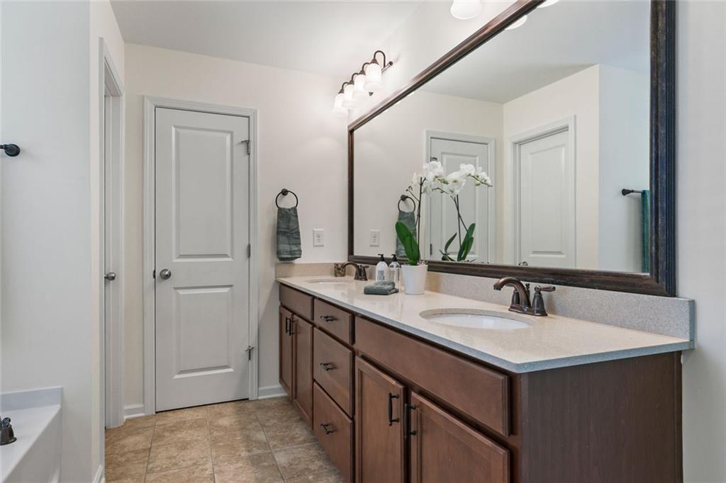 3935 Silver Springs Road Cumming, GA 30041 - Photo 20 of 37 a bathroom with a sink and a mirror