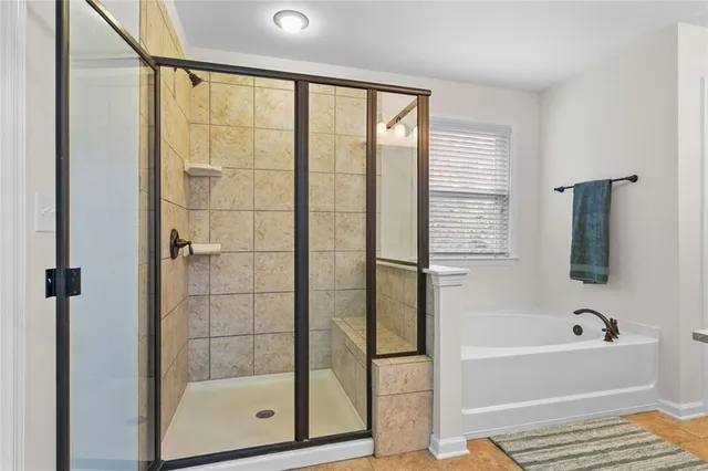 a bathroom with a bathtub and a shower