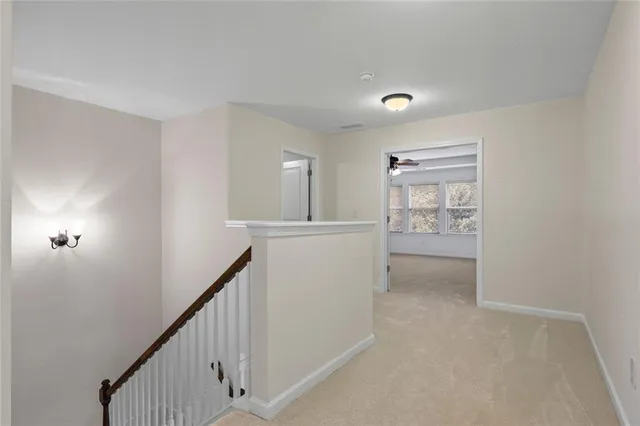 an empty room with a window and a ceiling fan