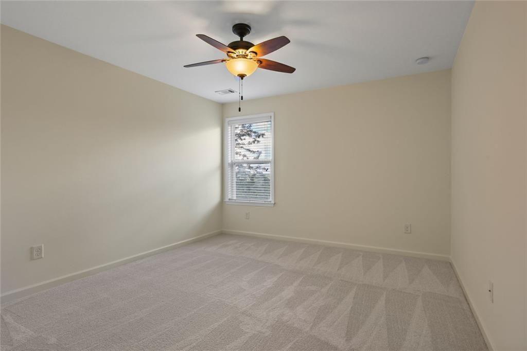 3935 Silver Springs Road Cumming, GA 30041 - Photo 24 of 37 an empty room with a window and a fan