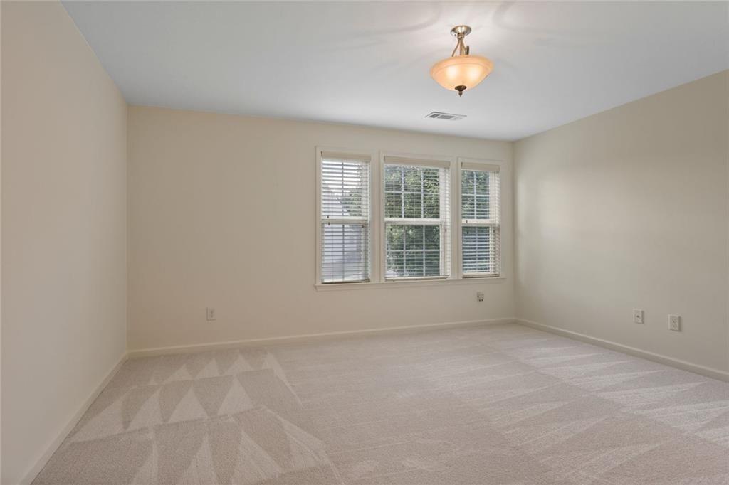 3935 Silver Springs Road Cumming, GA 30041 - Photo 26 of 37 wooden floor in an empty room with a window