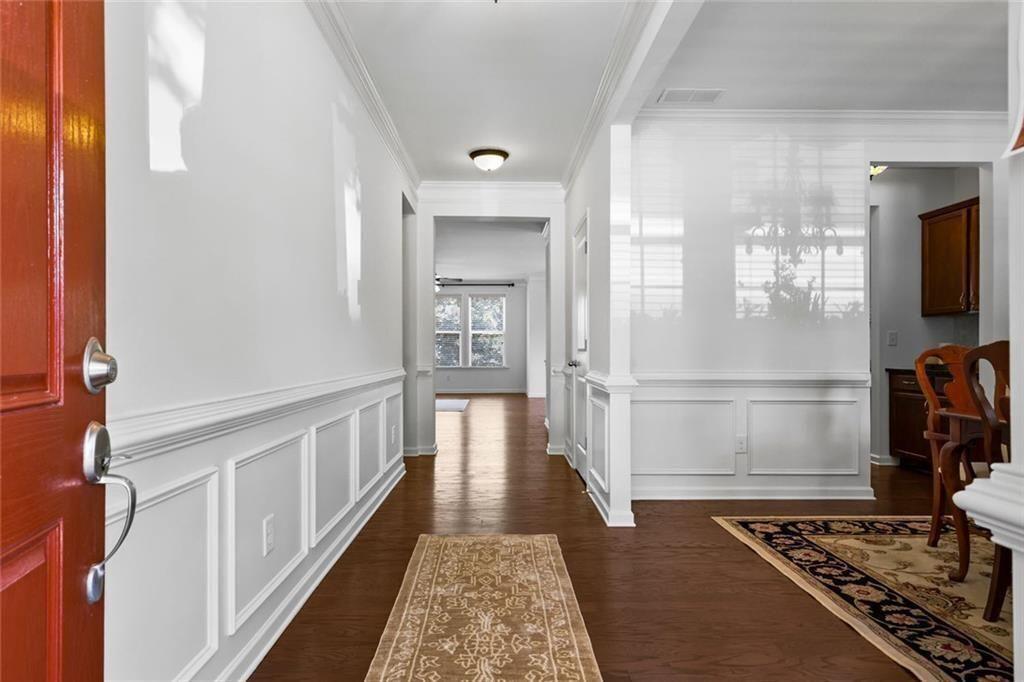 3935 Silver Springs Road Cumming, GA 30041 - Photo 4 of 37 a view of a hallway with wooden floor and staircase