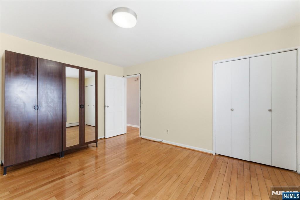 50-56 High Street, Unit 2 Passaic, NJ 07055 - Photo 14 of 30 an empty room with wooden floor and windows