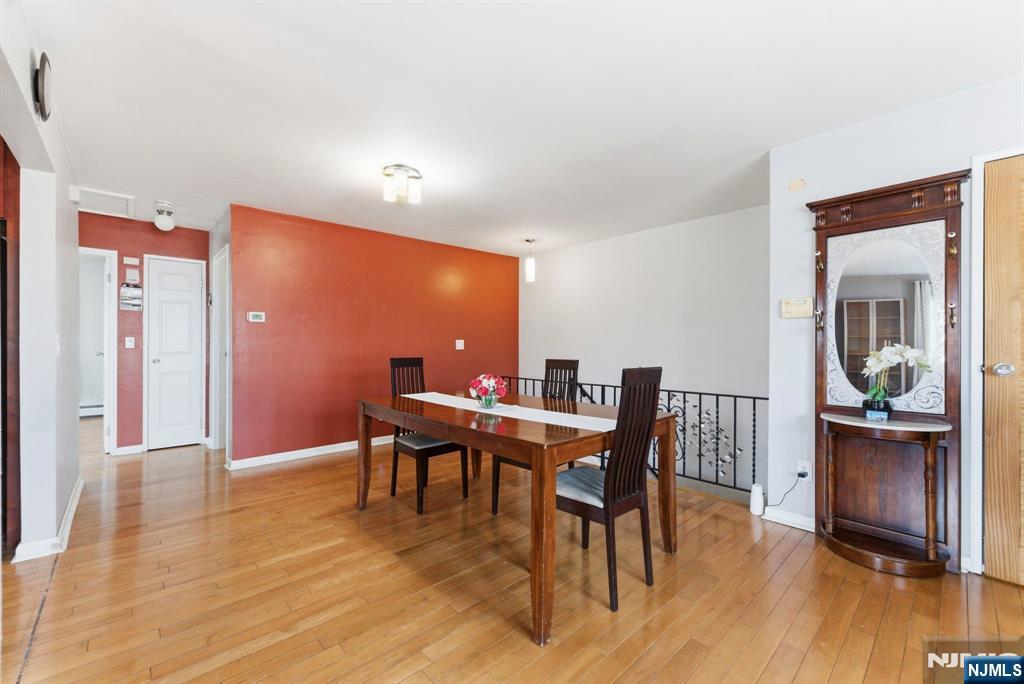 50-56 High Street, Unit 2 Passaic, NJ 07055 - Photo 21 of 30 a dining room with furniture wooden floor and a rug