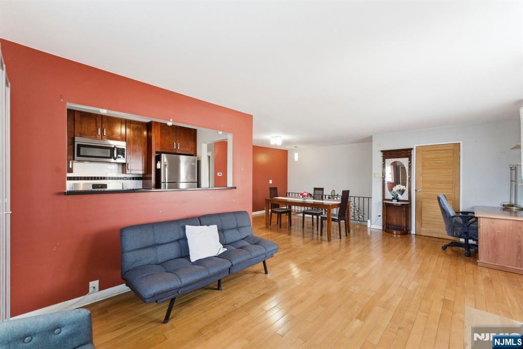 50-56 High Street, Unit 2 Passaic, NJ 07055 - Photo 6 of 30 a living room with furniture and a dining table