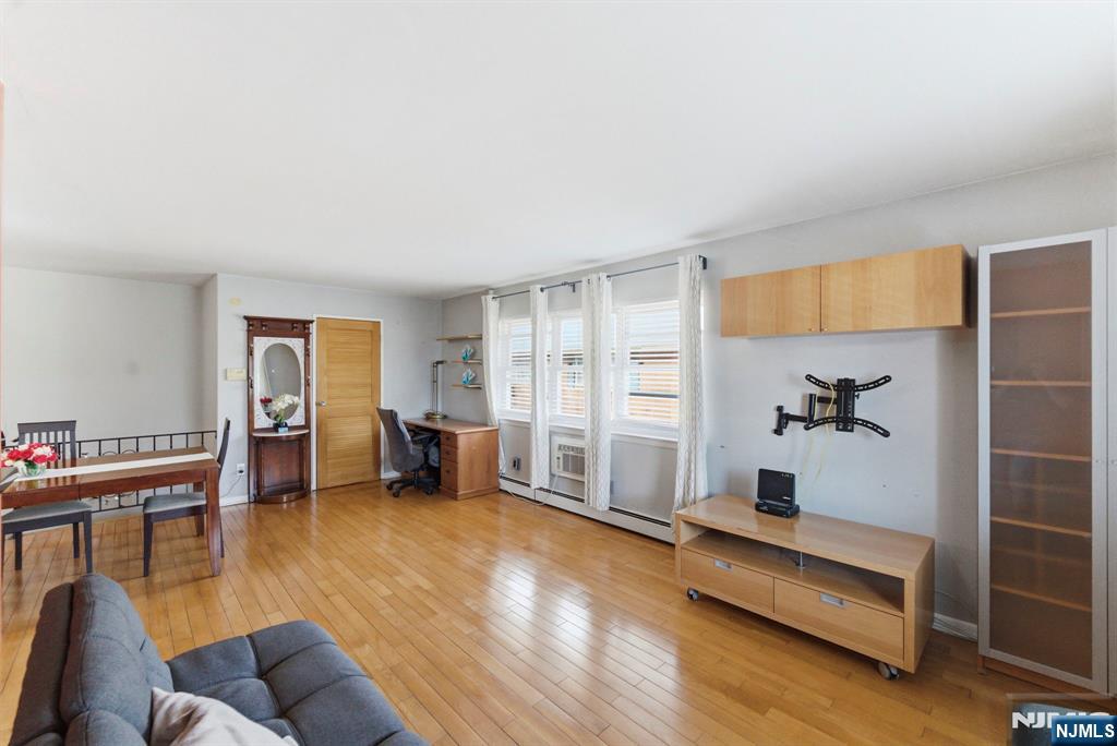 50-56 High Street, Unit 2 Passaic, NJ 07055 - Photo 7 of 30 a living room with furniture and wooden floor