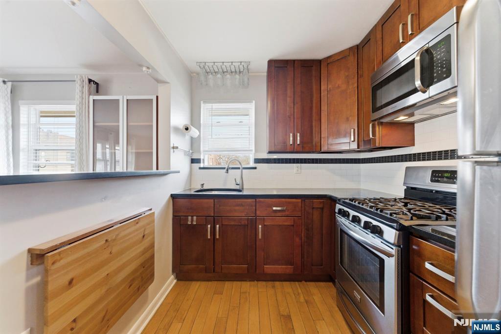 50-56 High Street, Unit 2 Passaic, NJ 07055 - Photo 9 of 30 a kitchen with stainless steel appliances granite countertop a stove and a sink