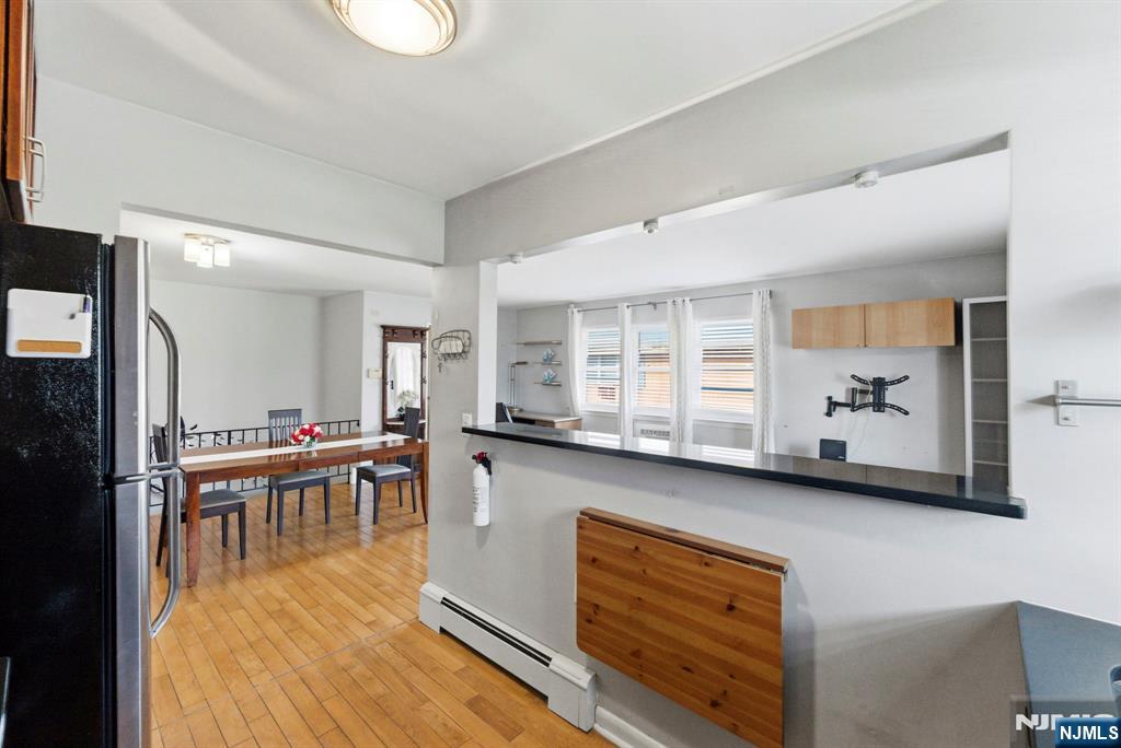 50-56 High Street, Unit 2 Passaic, NJ 07055 - Photo 10 of 30 a dining hall with stainless steel appliances kitchen island granite countertop a sink and cabinets