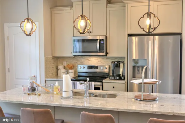 a kitchen with a appliances and chandelier