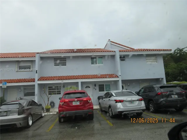 a front view of a house with cars
