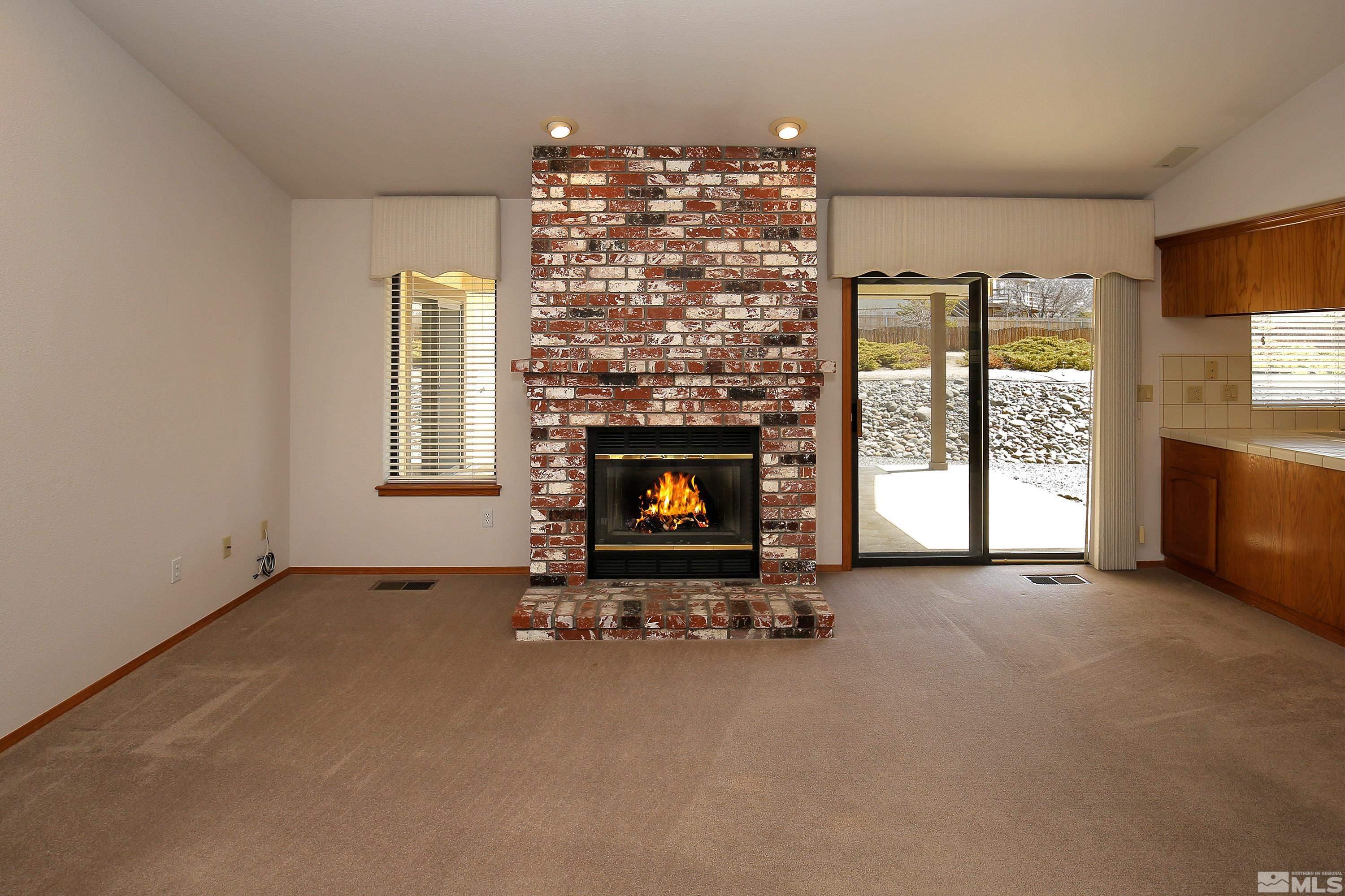 4521 Conte Drive Carson City, NV 89701 - Photo 9 of 35 an empty room with fireplace and windows