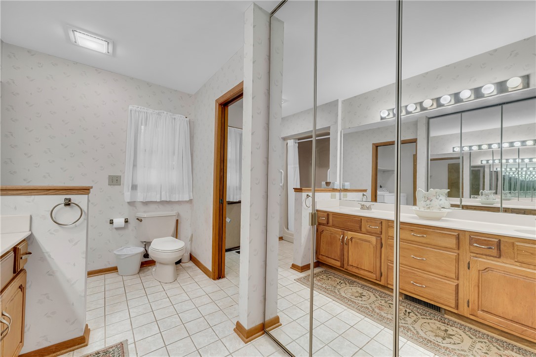 103 Colleton Court Clemson, SC 29631 - Photo 24 of 49 Tiled flooring and wood cabinetry define this functional bathroom with mirrored sliding closet doors.