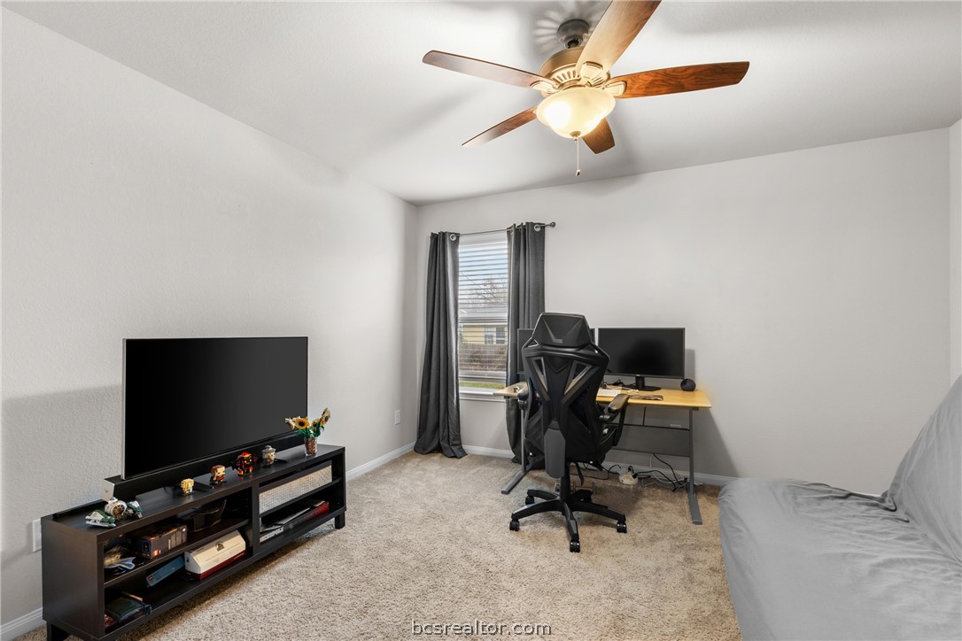 984 Crossing Drive Bryan, TX 77803 - Photo 18 of 29 a view of a workspace with furniture and a flat screen tv