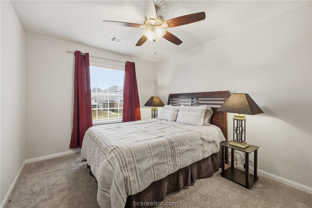 984 Crossing Drive Bryan, TX 77803 - Photo 19 of 29 a bed sitting in a bedroom next to a window