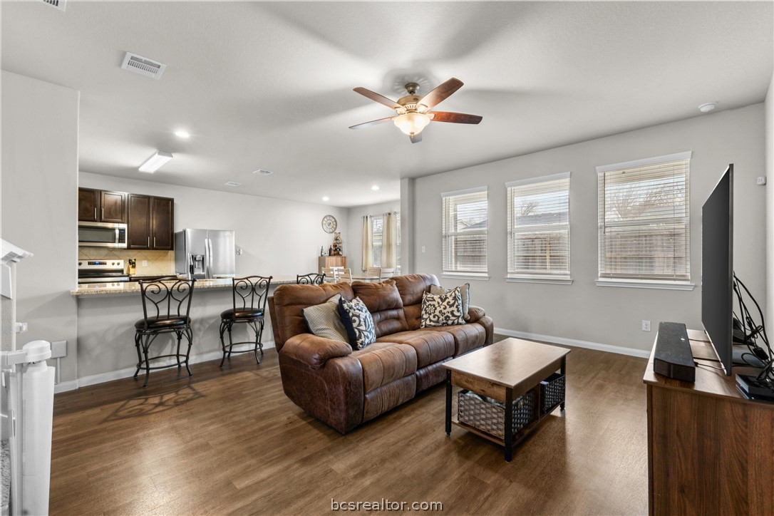 984 Crossing Drive Bryan, TX 77803 - Photo 6 of 29 a living room with furniture a fireplace and a flat screen tv