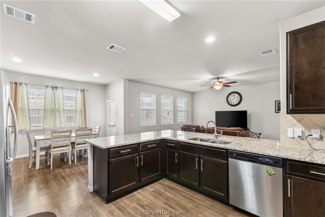 984 Crossing Drive Bryan, TX 77803 - Photo 10 of 29 a kitchen with a sink stove and cabinets