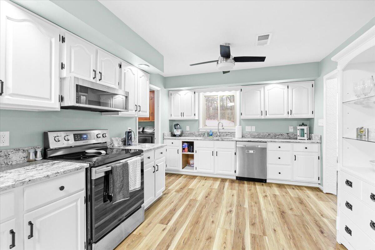 6742 Upper Craigs Creek Road Catawba, VA 24070 - Photo 20 of 23 a kitchen with stainless steel appliances white cabinets a sink a stove a refrigerator and white cabinets