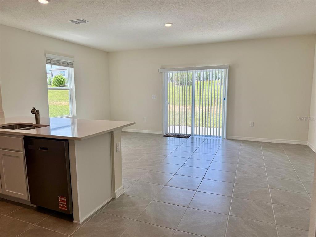 1642 Rock Elm Road Davenport, FL 33837 - Photo 11 of 27 a view of a kitchen with an empty space and a window