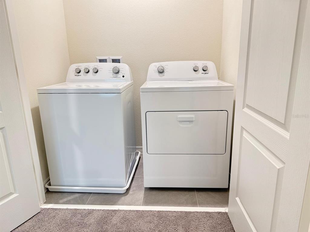 1642 Rock Elm Road Davenport, FL 33837 - Photo 23 of 27 a utility room with dryer and washer