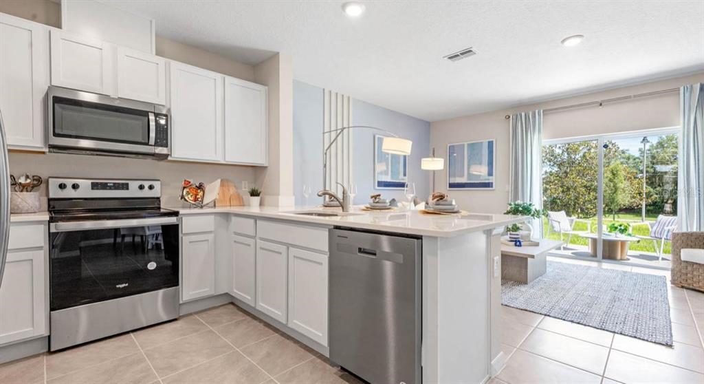1642 Rock Elm Road Davenport, FL 33837 - Photo 5 of 27 a kitchen with a sink stove and microwave