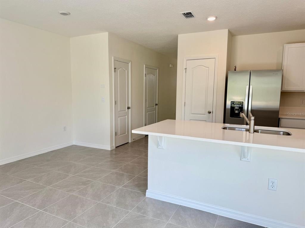 1642 Rock Elm Road Davenport, FL 33837 - Photo 9 of 27 a spacious bathroom with a tub and a double vanity sink