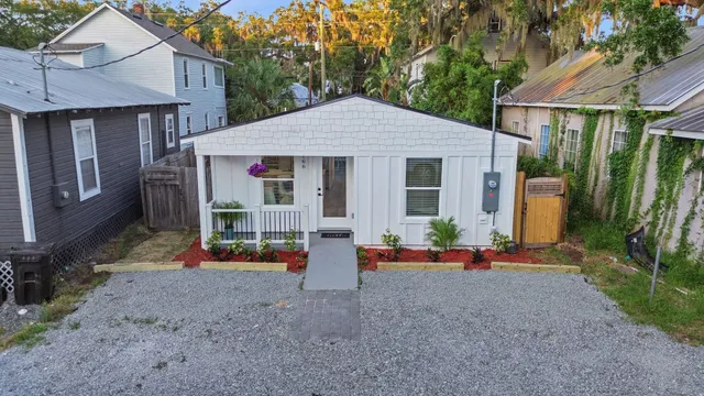 a view of a house with backyard and porch