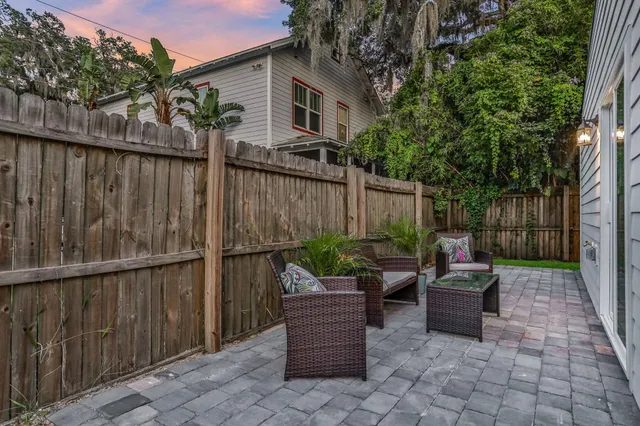 a view of a patio with table and chairs