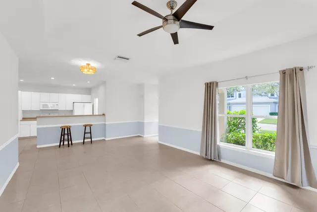 a view of a livingroom with furniture and a ceiling fan