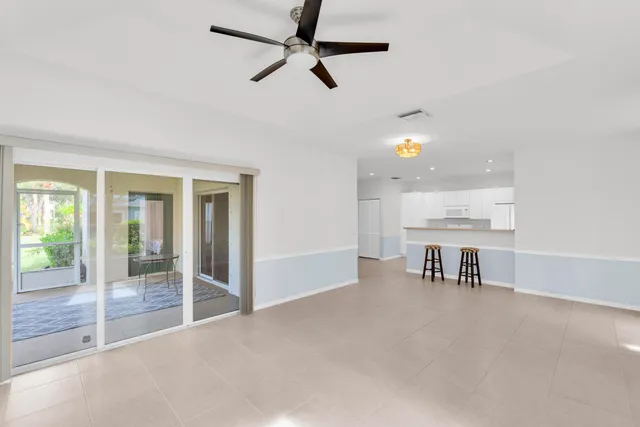a view of a livingroom with furniture and a ceiling fan
