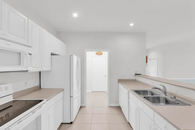 a kitchen with a sink and a refrigerator