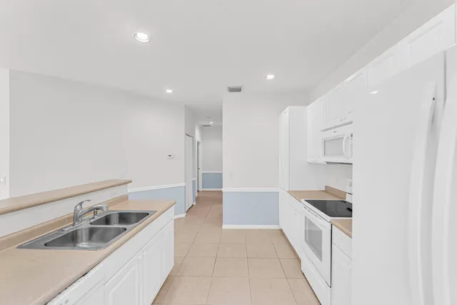 a kitchen with stainless steel appliances granite countertop a sink and cabinets