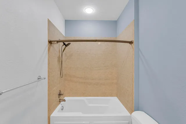 a bathroom with a bathtub and a shower