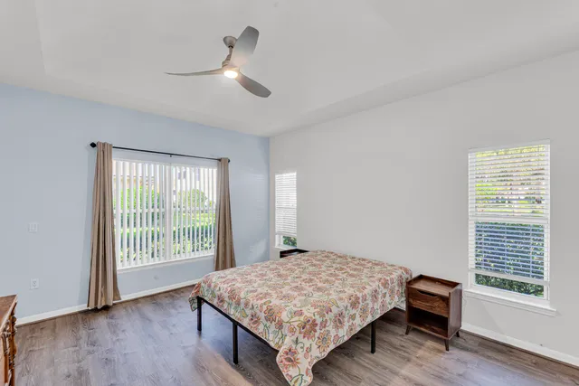 a bedroom with a bed and a large window